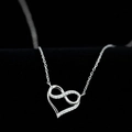 Silver infinity heart necklace with sparkling white zircons on a black velvet background - White Gold