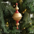 Vintage red and gold wooden Christmas finial ornament hanging on a pine tree - Gold