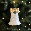 Creamy white Christmas bell ornament with gold bow and holly leaves hanging on a tree - Bell Style (APYX530-4)
