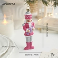 Pink soldier nutcracker ornament with purple candy on a festive Christmas tree background - Pink and White Soldier with Purple Candy (APYX627)
