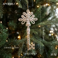 Vintage white and gold key ornament on a lighted Christmas tree branch - Key Style