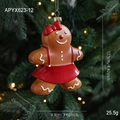 Gingerbread girl Christmas tree ornament with red bow and skirt details on green branches - Gingerbread Girl Style