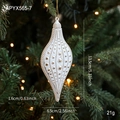 White and gold matte Christmas spindle ornament with embossed stars hanging on a tree - Conch Style