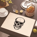 Linen placemat with black skull print on a wooden dining table with tableware - Black and White Line Skull (Style 18)