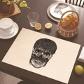 Linen placemat with black skull print on a dark wooden table with breakfast props - Detailed Screen Printed Skull (Style 20)