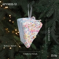 Pink Christmas foam cake ornament with blue layers and candy sprinkles on a tree - Blue Cake Style