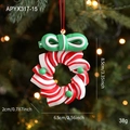 Red and white striped Christmas candy ornament with a green bow on a festive tree - Wreath A Style