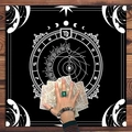 Detail of black tarot altar cloth with white mandala moon phase and zodiac chart - High Contrast Zodiac Compass