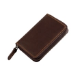Detailed macro of dark brown leather key pouch with orange contrast stitching and metal zipper - Coffee