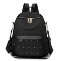 Chic black nylon backpack with quilted triangular pocket and gold studs in front view - Black