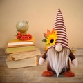 Detailed close-up of a seasonal gnome doll with sunflower and maple leaf on its hat - Beard Style