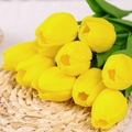 Realistic artificial yellow tulip bouquet with detailed green leaves on woven mat - Yellow