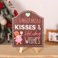 Nahaufnahme vom Lebkuchen-Küsse Holzschild mit festlicher Figur und Stativständer - Braunes Lebkuchen-Mädchen (GINGERBREAD KISSES)