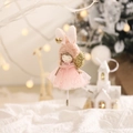 Pink rabbit ear angel doll with golden wings hanging on a Christmas tree branch - Pink