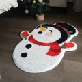 Festive snowman shaped plush rug with red scarf and black hat on dark wood floor - Snowman / 55x74cm