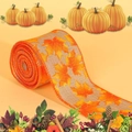 Close-up of orange burlap ribbon with maple leaf prints for autumn festival decor - Gray Background Maple Leaf Style