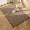 Brown and white striped durable indoor doormat on parquet floor with white sneakers - Coffee