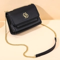 Classic black leather crossbody bag with golden hardware and chain strap details - Black