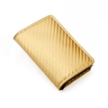 Macro detail of golden business card holder featuring carbon fiber texture and fine stitching - Carbon Fiber Gold
