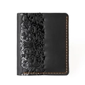 Detail of vintage black leather wallet showing floral embossing and orange contrast stitching - 8031 Vertical Black Floral