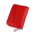 Macro view of red litchi texture leather card holder with silver metal zipper detail - Red