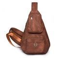 Detail view of brown vintage textured crossbody bag with multi-pocket design and D-ring - Caramel color