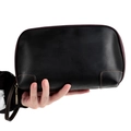 Detailed view of hand-held vintage black leather clutch bag with brown stitching - Black
