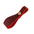 Detailed macro view of crazy horse leather strap with a vintage brass metal rivet - Red