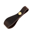 Close-up of vintage brown leather drawer handle with a classic brass metal rivet - Coffee