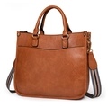 Brown faux leather handbag with striped wide strap and gold hardware accessories - Brown