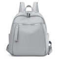 Close-up of light grey litchi grain leather texture and silver zipper hardware on backpack - Gray