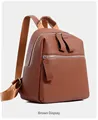 Detailed view of the brown lychee-textured PU leather backpack with silver zippers - Brown