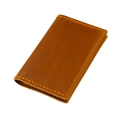 Close-up of vintage crazy horse leather card holder with thick orange stitching detail - Brown