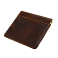 Macro detail of crazy horse leather coin purse with yellow stitching and metal snap closure - Coffee