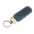 Detail view of vintage crazy horse leather keychain with contrast stitching and brass hook - Blue