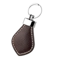 Macro detail of dark brown lychee grain leather keychain with white contrast stitching - Coffee