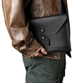 Detail of minimalist black leather laptop sleeve with envelope closure and tie-up fastener - Black