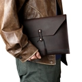 Detail of dark brown leather envelope sleeve with vintage string closure for laptops - Coffee