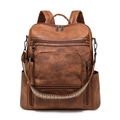Detail view of brown PU leather backpack showing ethnic woven strap and tassel charm - Two-tone Brown Coarse Grain