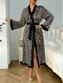 Detail of leopard print satin robe featuring contrast black trim and adjustable waist tie - S / Leopard Print
