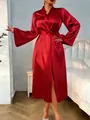 Detail of a luxury red satin bathrobe featuring a smooth silky texture and V-neckline - S / Red