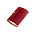 Detail view of wine red leather card holder with retro texture and gold rivet button - Red