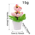 Oster-Blumentopf mit rosa gesprenkelten Eiern und grünen Blättern im weißen Topf - Rosa