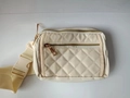 Quilted cream fanny pack with golden zippers and adjustable strap in a variant view - Beige