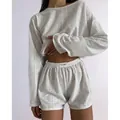 Detail of white long sleeve top and high-waisted shorts with breathable hollow texture - White