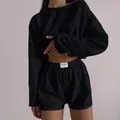 Close-up of black two-piece lounge set showing textured fabric and elastic waistband - Black