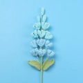 Detailed close-up of handmade crochet gradient blue lilac flowers and green stem - Gradient Blue