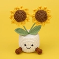 Detail der handgehäkelten Sonnenblume im niedlichen Topf mit lachendem Gesicht - Zweiköpfige Sonnenblume (Weißer Topf mit Füßen)
