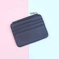 Detail view of black pebbled leather card holder with three slots and gold zipper - Black
