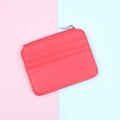 Detailed view of red pebble leather zipper card holder with three vertical card slots - Red